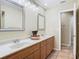 Double vanity bathroom with wood cabinets and large mirrors at 1469 Grace Lake Cir, Longwood, FL 32750