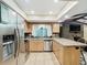 Kitchen with stainless steel appliances and light wood cabinets at 1469 Grace Lake Cir, Longwood, FL 32750