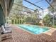 Inviting screened pool with brick patio and lounge chairs at 1469 Grace Lake Cir, Longwood, FL 32750