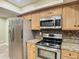 Modern kitchen featuring stainless steel appliances and tile backsplash at 1469 Grace Lake Cir, Longwood, FL 32750