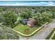 Aerial view of a house with a pool and lush green landscaping at 1469 Grace Lake Cir, Longwood, FL 32750