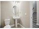 Simple bathroom with pedestal sink and oval mirror at 11944 Bracco St, Winter Garden, FL 34787