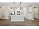 Modern kitchen with a large island and white cabinets at 11944 Bracco St, Winter Garden, FL 34787
