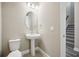 Clean and modern bathroom with pedestal sink and oval mirror at 11960 Bracco St, Winter Garden, FL 34787