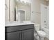 Clean bathroom with gray vanity, white toilet, and bathtub at 11960 Bracco St, Winter Garden, FL 34787