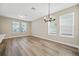Dining area with wood-look floors and a chandelier at 11960 Bracco St, Winter Garden, FL 34787