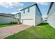 Attached garage with brick paver driveway and landscaping at 11960 Bracco St, Winter Garden, FL 34787