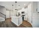 Modern kitchen with white cabinets, stainless steel appliances, and quartz countertops at 11960 Bracco St, Winter Garden, FL 34787