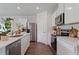 Modern kitchen with stainless steel appliances and white shaker cabinets at 5441 Hayloft Dr, Apopka, FL 32712