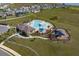 Aerial view of community pool, playground, and clubhouse at 14569 Crestavista Dr, Clermont, FL 34714