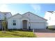 New single-story home with light gray siding and two-car garage at 14569 Crestavista Dr, Clermont, FL 34714