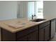 Modern kitchen island with quartz countertop, stainless steel sink, and dark brown cabinets at 14569 Crestavista Dr, Clermont, FL 34714
