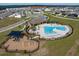 Aerial view showing community pool, playground and surrounding homes at 14569 Crestavista Dr, Clermont, FL 34714