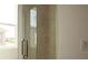 Modern shower with frameless glass enclosure and beige tile at 14569 Crestavista Dr, Clermont, FL 34714
