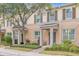 Two-story tan townhouse with shutters and landscaping at 8253 Maritime Flag St # 125, Windermere, FL 34786