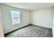 Bright bedroom with gray carpet and large window at 14556 Crestavista Dr, Clermont, FL 34714