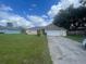 Single-story house with a two-car garage and spacious lawn at 2391 Moonstone Ave, Deltona, FL 32738