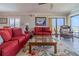 Living room with ocean view, red couches and arm chair at 5303 S Atlantic Ave # 35, New Smyrna Beach, FL 32169