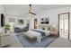 Spacious bedroom with king-size bed, two armchairs and access to a private patio at 7904 Dunstable Cir, Orlando, FL 32817