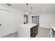 Modern kitchen island with white cabinets and dark brown drawers at 7904 Dunstable Cir, Orlando, FL 32817