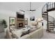 Bright living room with fireplace, spiral staircase, and open floor plan at 7904 Dunstable Cir, Orlando, FL 32817