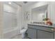 Bathroom with granite countertop, gray cabinets, and bathtub at 6146 Galloping Dr, Apopka, FL 32712