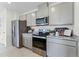 Stainless steel appliances and gray cabinets in this well-lit kitchen at 6146 Galloping Dr, Apopka, FL 32712