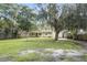 House with a large grassy front yard and mature trees at 5625 Chipola Cir, Orlando, FL 32839