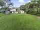 Large backyard with grassy area and mature trees at 5625 Chipola Cir, Orlando, FL 32839