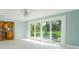 Gathering room with view into kitchen and access to backyard at 5625 Chipola Cir, Orlando, FL 32839