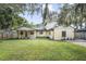 Spacious backyard with grassy lawn and mature trees at 5625 Chipola Cir, Orlando, FL 32839