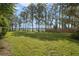 Large backyard with lush grass and lake view at 5625 Chipola Cir, Orlando, FL 32839