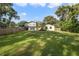 Large backyard with a two-story house and a wooden fence at 5625 Chipola Cir, Orlando, FL 32839