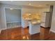 Kitchen with island, white cabinets, and hardwood floors at 5625 Chipola Cir, Orlando, FL 32839