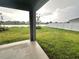 Covered patio overlooking a tranquil backyard and lake at 420 Quarry Rock Cir, Kissimmee, FL 34758