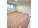 Spacious bedroom with plush carpeting and large window at 420 Quarry Rock Cir, Kissimmee, FL 34758