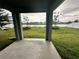 Covered patio with a view of the lake and green backyard at 420 Quarry Rock Cir, Kissimmee, FL 34758