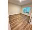 Large bedroom with wood-look floors and a window at 420 Quarry Rock Cir, Kissimmee, FL 34758