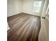 Bright bedroom featuring hardwood floors and a large window at 420 Quarry Rock Cir, Kissimmee, FL 34758