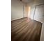 Spacious bedroom with wood-look flooring and ample closet space at 420 Quarry Rock Cir, Kissimmee, FL 34758