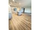 Open concept kitchen and living room with light gray cabinets and wood-look flooring at 420 Quarry Rock Cir, Kissimmee, FL 34758