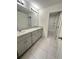 Modern bathroom with double vanity and tiled floor at 420 Quarry Rock Cir, Kissimmee, FL 34758