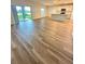 Spacious living room with kitchen and sliding glass doors leading to backyard at 420 Quarry Rock Cir, Kissimmee, FL 34758