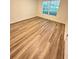 Bright bedroom featuring wood-look floors and large window at 420 Quarry Rock Cir, Kissimmee, FL 34758