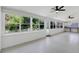 Bright sunroom with tile floors, ceiling fans, and multiple windows offering backyard views at 7904 Dunstable Cir, Orlando, FL 32817