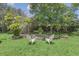Relaxing backyard with firepit, lush landscaping and two white chairs at 7904 Dunstable Cir, Orlando, FL 32817