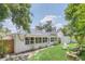 Landscaped backyard with grassy lawn, stone features, and mature trees at 7904 Dunstable Cir, Orlando, FL 32817