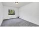 Simple bedroom with grey carpet and a window at 7904 Dunstable Cir, Orlando, FL 32817