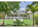 Private backyard oasis with lush landscaping and two white chairs at 7904 Dunstable Cir, Orlando, FL 32817