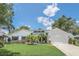 White house with a brick facade, two-car garage and palm trees at 7904 Dunstable Cir, Orlando, FL 32817